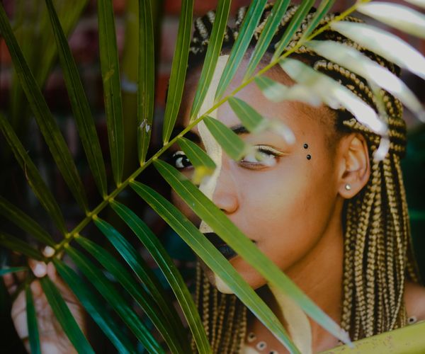 Pretty girl behind plant