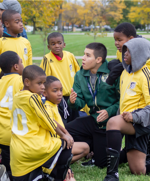 Football coach instructing young players